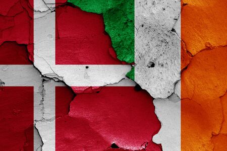 flags of Denmark and Ireland painted on cracked wallの写真素材