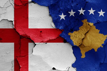 flags of England and Kosovo painted on cracked wallの写真素材