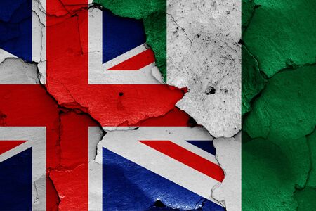 flags of UK and Nigeria painted on cracked wallの写真素材
