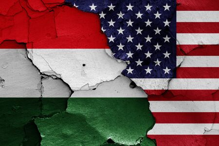 flags of Hungary and USA painted on cracked wallの写真素材