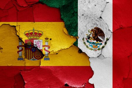 flags of Spain and Mexico painted on cracked wallの写真素材