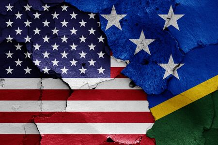 flags of USA and Solomon Islands painted on cracked wallの写真素材