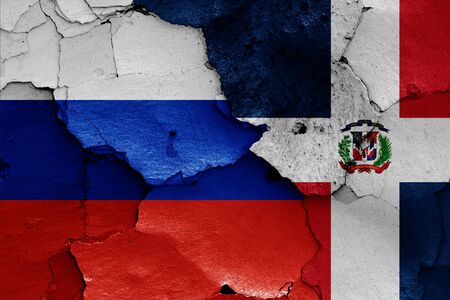 flags of Russia and Dominican Republic painted on cracked wallの写真素材