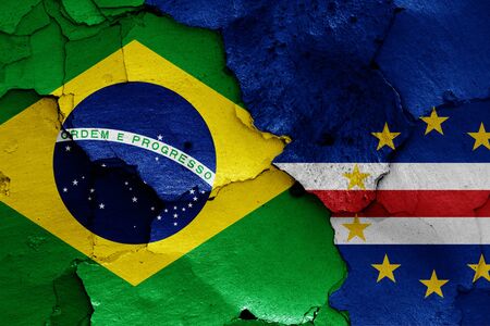 flags of Brazil and Cape Verde painted on cracked wallの写真素材