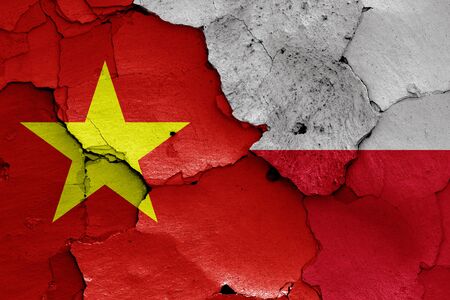 flags of Vietnam and Poland painted on cracked wallの写真素材