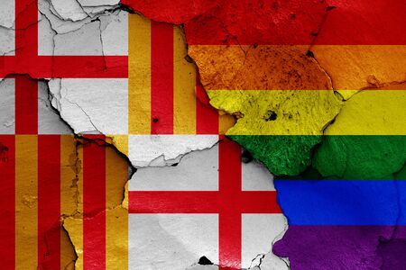 flags of Barcelona and LGBT painted on cracked wallの写真素材