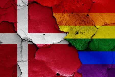 flags of Denmark and LGBT painted on cracked wallの写真素材