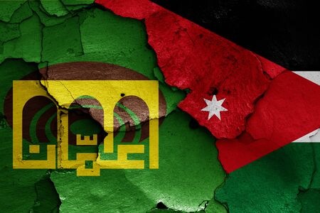 flags of Amman and Jordan painted on cracked wallの写真素材