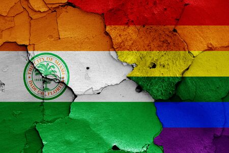 flags of Miami and LGBT painted on cracked wallの写真素材