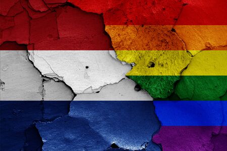 flags of Netherlands and LGBT painted on cracked wallの写真素材