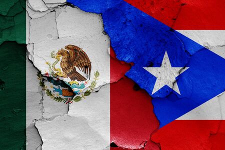 flags of Mexico and Puerto Rico painted on cracked wallの写真素材