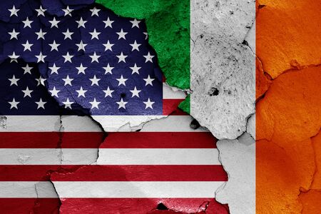 flags of USA and Ireland painted on cracked wallの写真素材