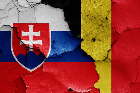 flags of Slovakia and Belgium painted on cracked wallの写真素材