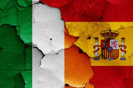 flags of Ireland and Spain painted on cracked wallの写真素材