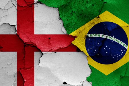 flags of England and Brazil painted on cracked wallの写真素材