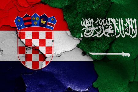 flags of Croatia and Saudi Arabia painted on cracked wallの写真素材
