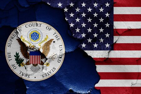 flags of Supreme Court of the United States and USA painted on cracked wallの写真素材