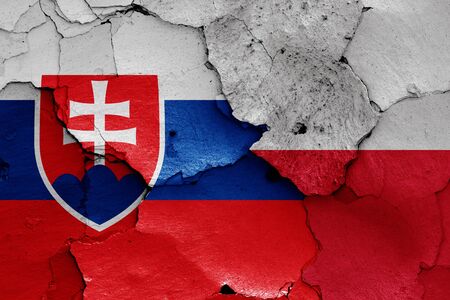 flags of Slovakia and Poland painted on cracked wallの写真素材