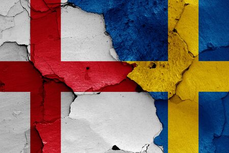 flags of England and Sweden painted on cracked wallの写真素材