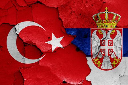 flags of Turkey and Serbia painted on cracked wallの写真素材