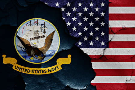 flags of United States Navy and USA painted on cracked wallの写真素材
