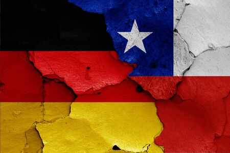 flags of Germany and Chile painted on cracked wallの写真素材