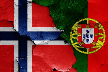 flags of Norway and Portugal painted on cracked wallの写真素材