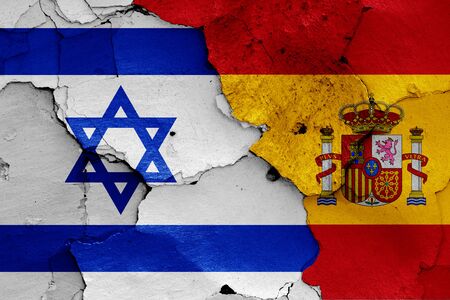 flags of Israel and Spain painted on cracked wallの写真素材