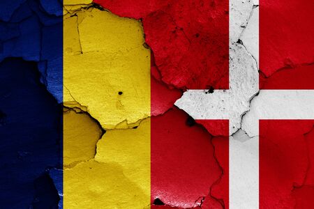 flags of Romania and Denmark painted on cracked wallの写真素材