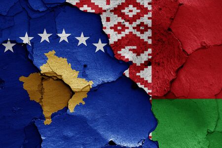 flags of Kosovo and Belarus painted on cracked wallの写真素材