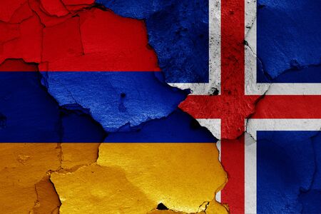 flags of Armenia and Iceland painted on cracked wallの写真素材