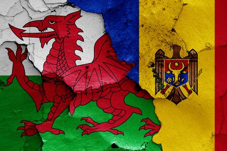 flags of Wales and Moldova painted on cracked wallの写真素材