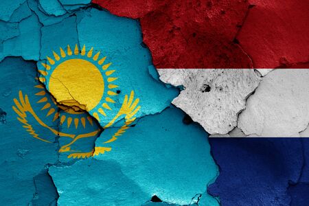 flags of Kazakhstan and Netherlands painted on cracked wallの写真素材