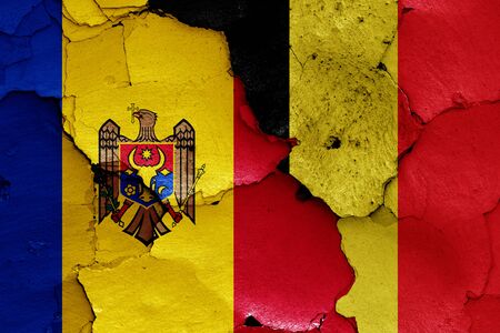 flags of Moldova and Belgium painted on cracked wallの写真素材