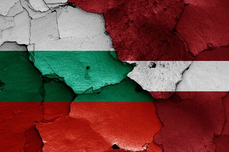 flags of Bulgaria and Latvia painted on cracked wallの写真素材