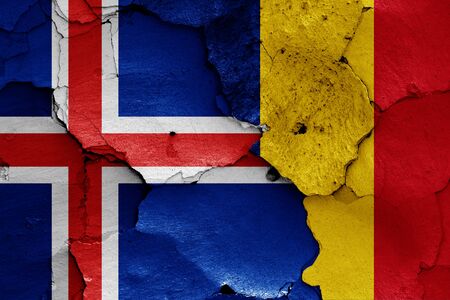 flags of Iceland and Romania painted on cracked wallの写真素材