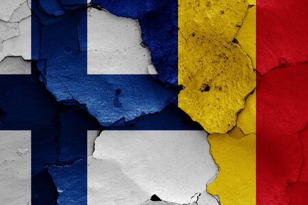 flags of Finland and Romania painted on cracked wallの写真素材