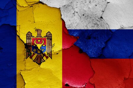 flags of Moldova and Russia painted on cracked wallの写真素材