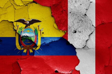 flags of Ecuador and Peru painted on cracked wallの写真素材