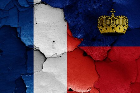 flags of France and Liechtenstein painted on cracked wallの写真素材