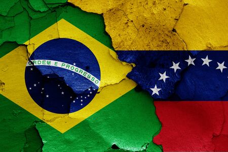 flags of Brazil and Venezuela painted on cracked wallの写真素材