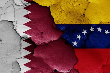 flags of Qatar and Venezuela painted on cracked wallの写真素材