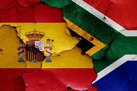 flags of Spain and South Africa painted on cracked wallの写真素材