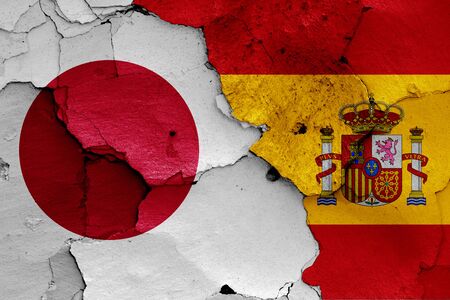 flags of Japan and Spain painted on cracked wallの写真素材