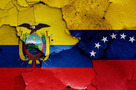 flags of Ecuador and Venezuela painted on cracked wallの写真素材