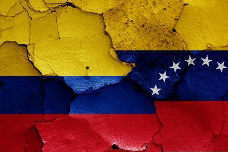 flags of Colombia and Venezuela painted on cracked wallの写真素材