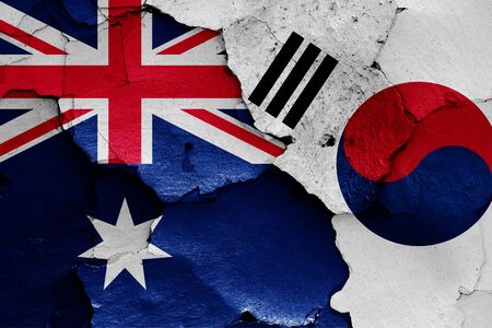flags of Australia and South Korea painted on cracked wallの写真素材