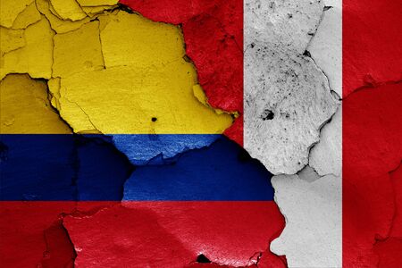 flags of Colombia and Peru painted on cracked wallの写真素材