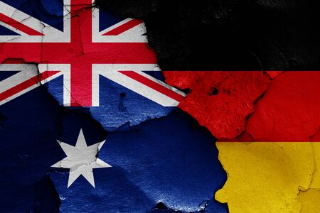 flags of Australia and Germany painted on cracked wallの写真素材
