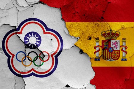 flags of Chinese Taipei and Spain painted on cracked wallの写真素材
